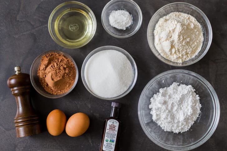 Ingredients for crinkle cookies with flour, cocoa powder, sugar, eggs, vanilla, oil