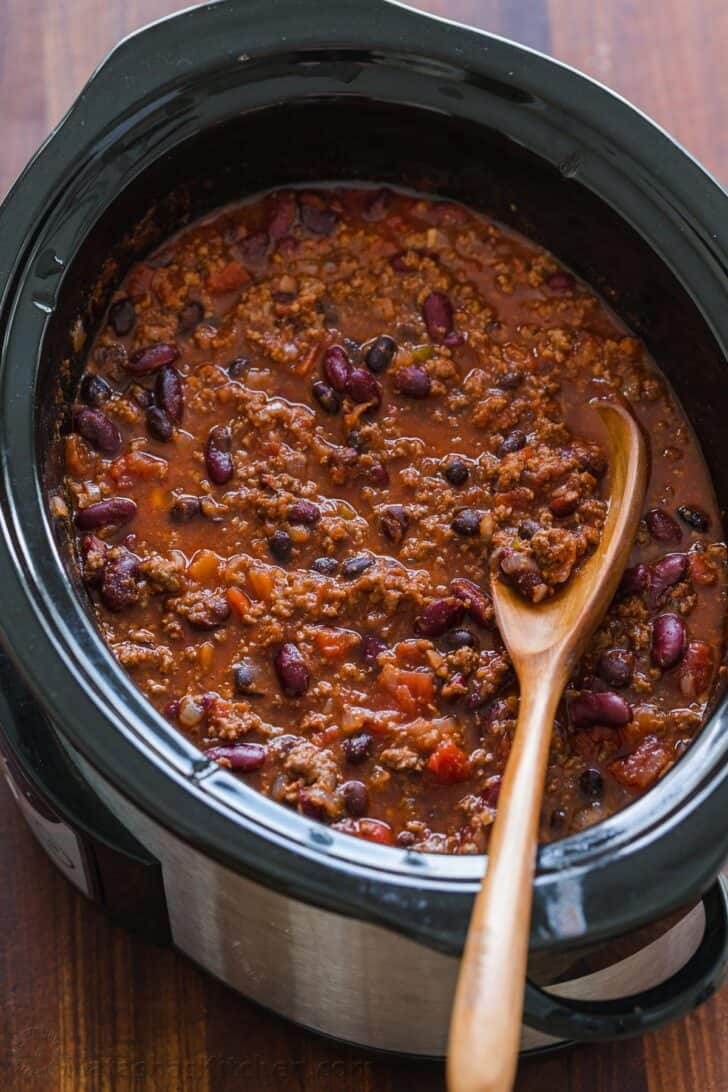 Chili in a slow cooker with spoon